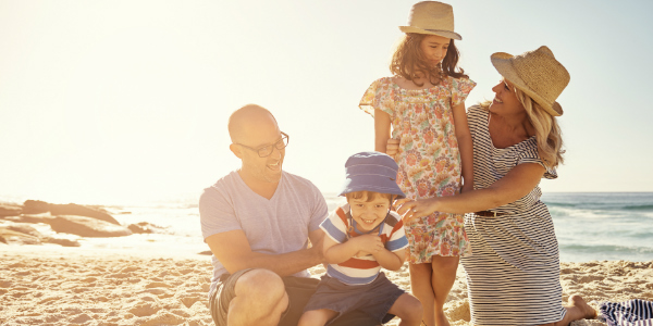 Family of four ecpats on the beach
