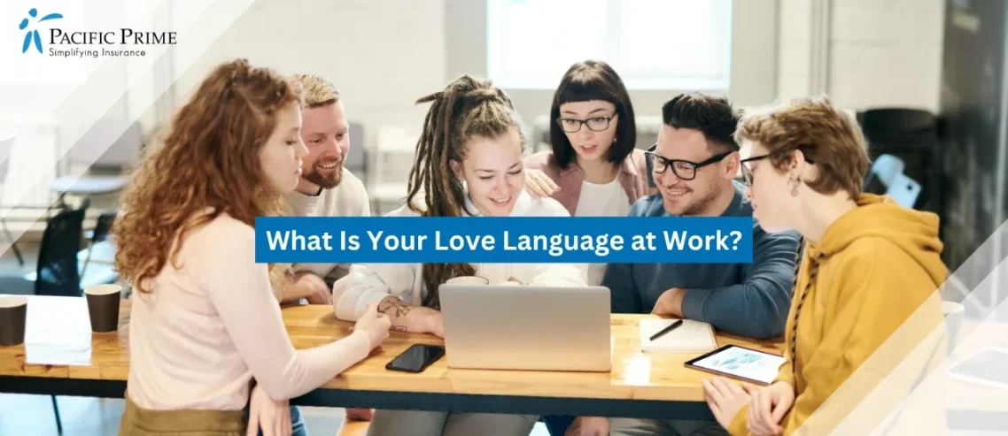Image of Diverse Coworkers Smiling While Discussing At A Laptop with text overlay of "What Is Your Love Language at Work?"